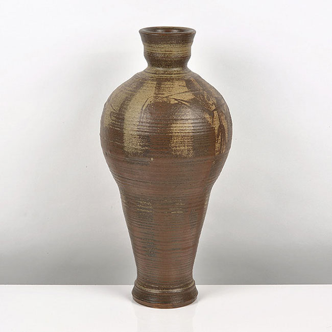 A brown stoneware vessel made by R J Washington in 1981 sold at auction by Maak Contemporary Ceramics