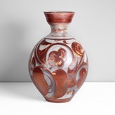 A earthenware with red lustre large bottle vase made by Alan Caiger-Smith in 1984 sold at auction by Maak