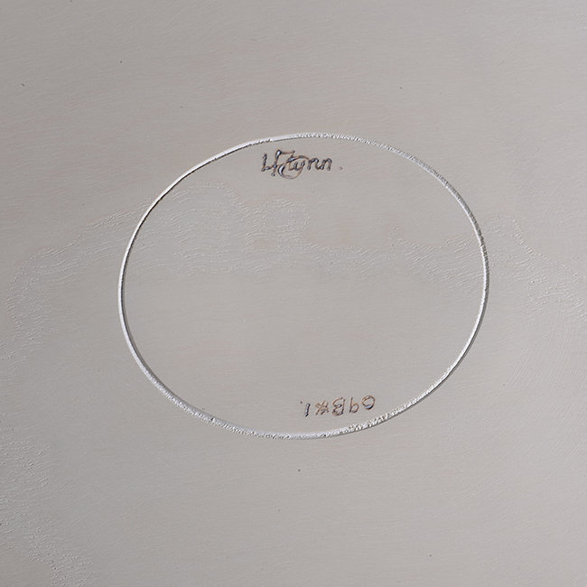 An incised signature on an ash vessel made by Liam Flynn