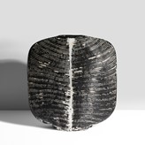 Earthenware, layered black and white tin glazes over a carved ribbed surface, incised signature and date