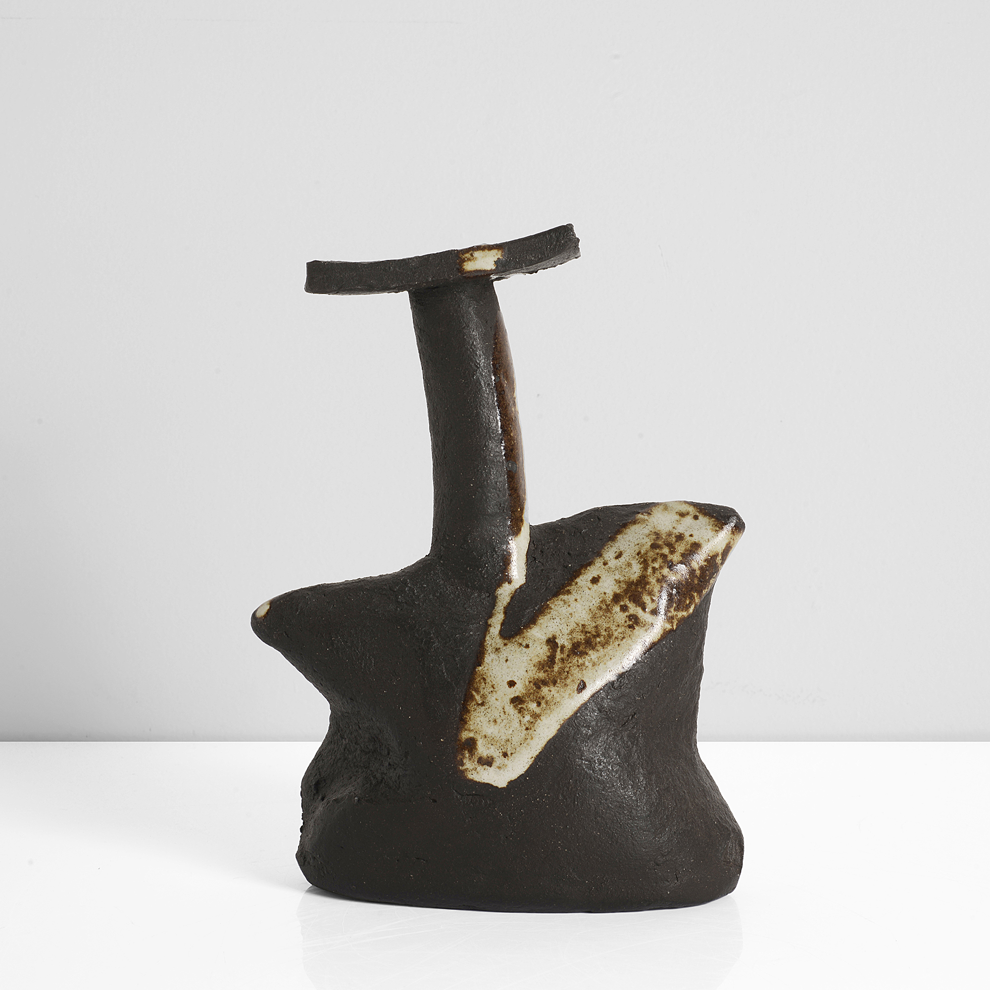 Janet Leach | Stoneware, matt black body with white splashes over the compressed, distorted body, cylindrical neck and rectangular lip, impressed JL and Leach Pottery seals