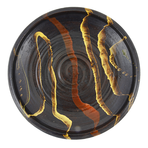 A brown earthenware charger made by Clive Bowen sold at auction by Maak Contemporary Ceramics