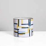A porcelain cylinder with blue, black and yellow design made by Bodil Manz sold at auction by Maak