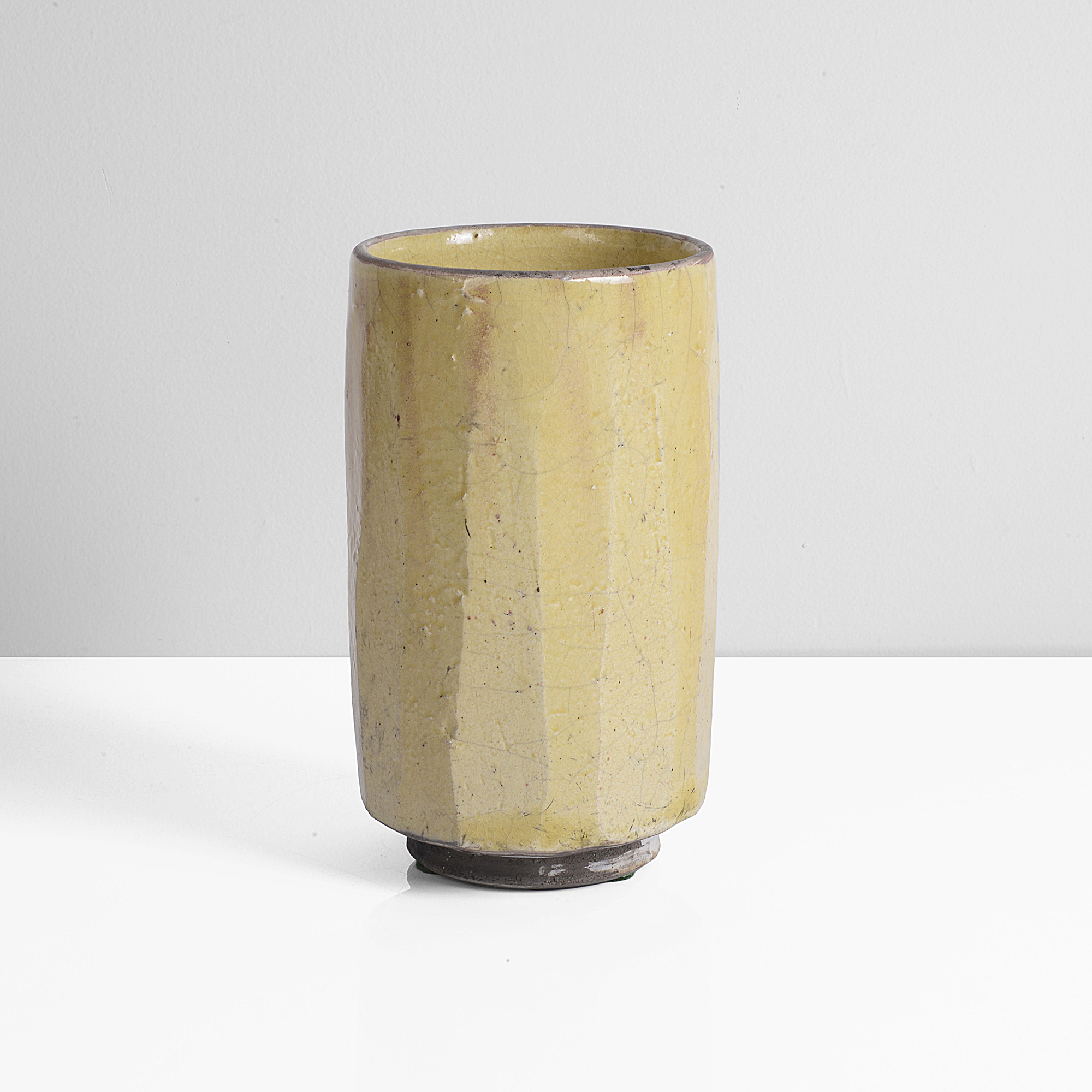 Raku, dark grey body with thick yellow crackle glaze, strong green splashes and black deposits to the surface, the rim unglazed, impressed IR seal