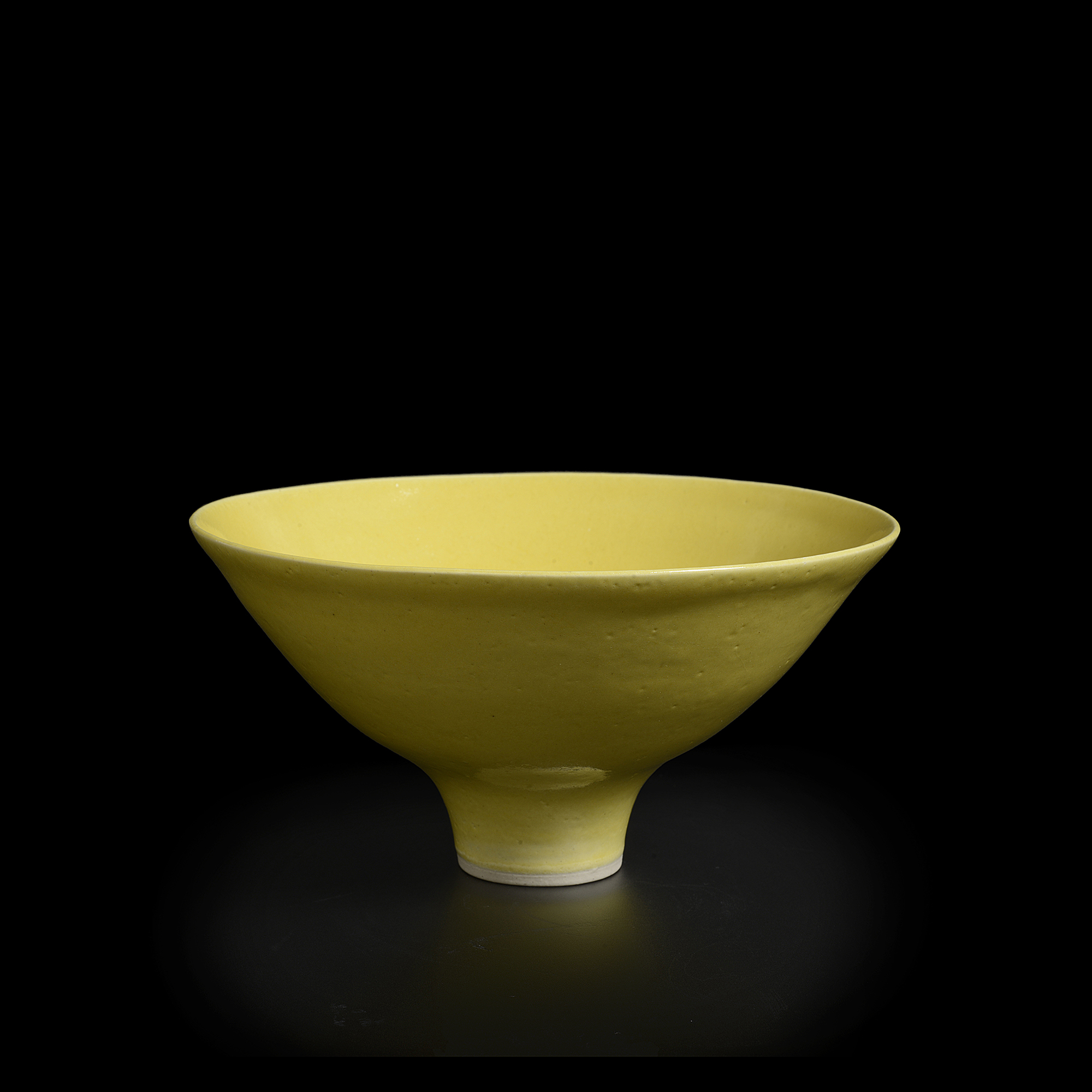 A yellow porcelain bowl made by Lucie Rie in circa 1970