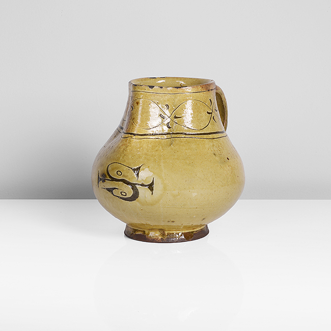 An earthenware slipware pitcher made by Bernard Leach in circa 1922 sold at auction by Maak
